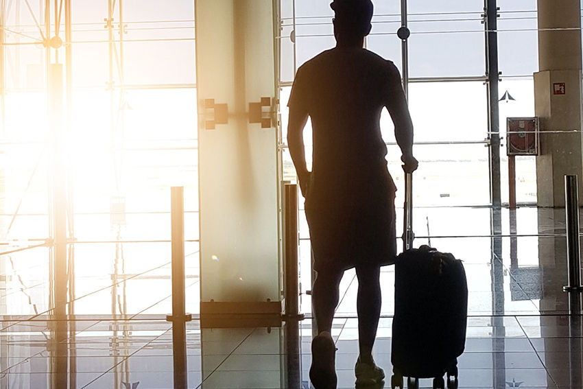 Business traveller at airport with luggage